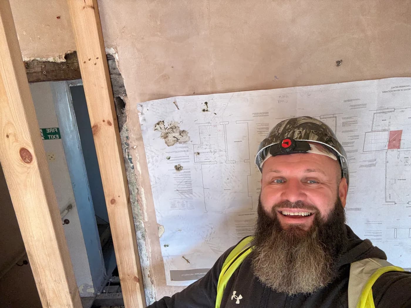 Architect's drawings laid out on site during a refurbishment.