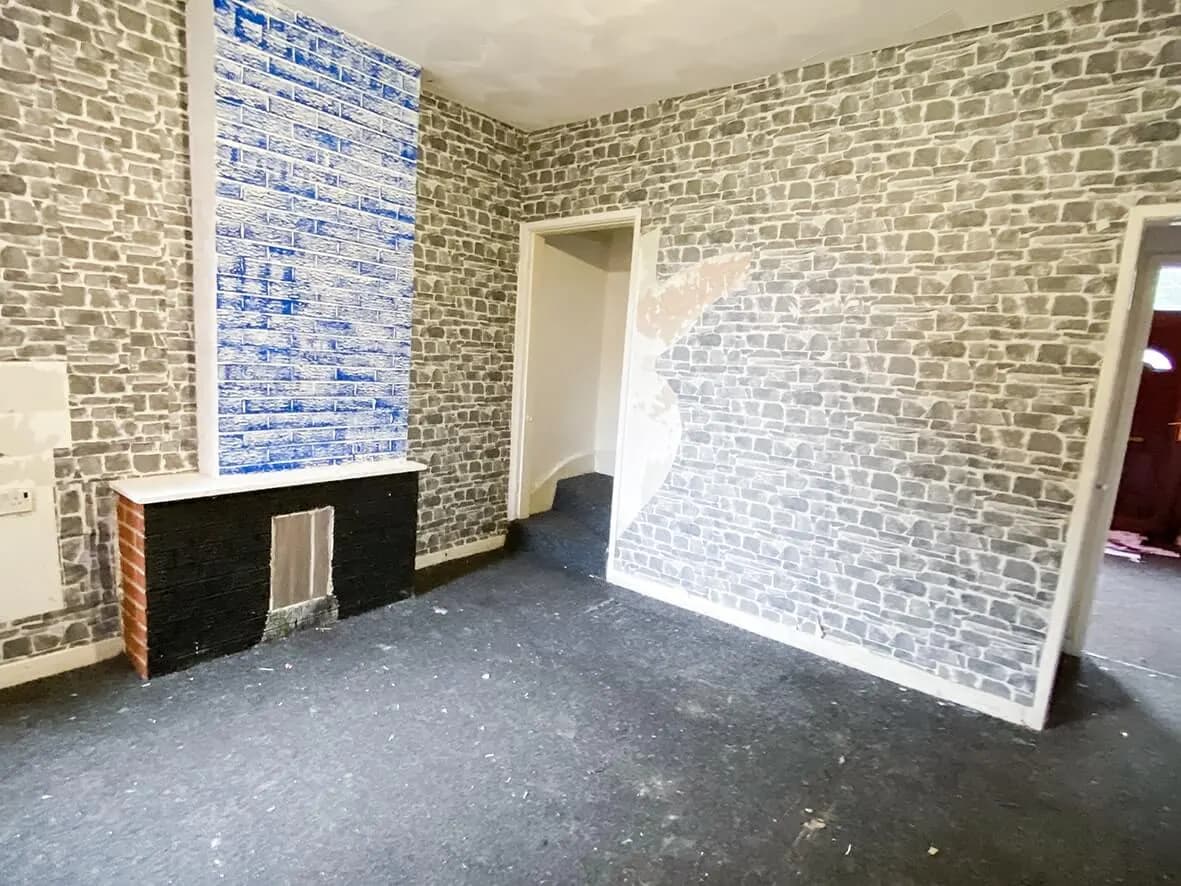 Before · brick-effect wallpaper in the back room
