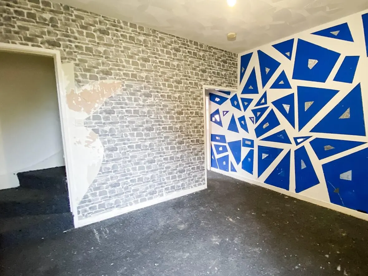 Before · blue geometric feature wall painted onto plaster