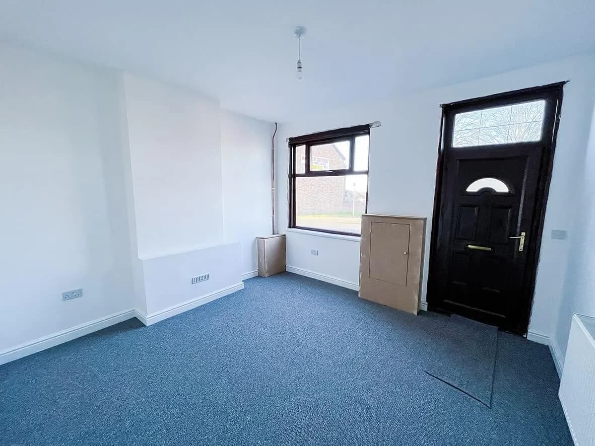 Complete · lounge decorated and carpeted with the new front door